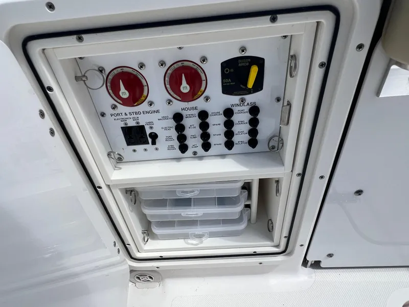 Slide: The Image of Control panel of a 2016 Pursuit S 280 Sport boat, featuring switches and storage compartments. - 27