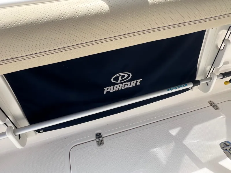 Slide: The Image of 2016 Pursuit S 280 Sport boat interior with branded cover and storage compartment. - 30