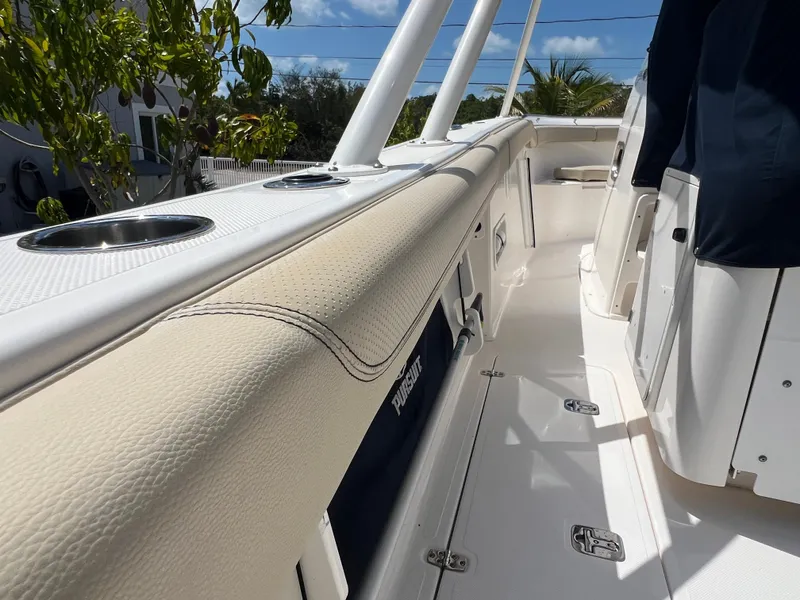 Slide: The Image of 2016 Pursuit S 280 Sport boat interior with cushioned seating and cup holders. - 31