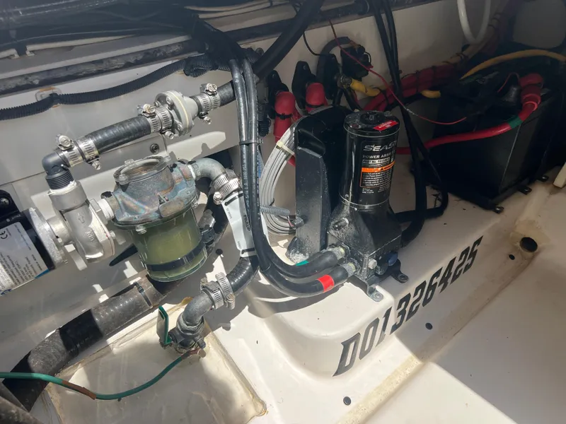 Slide: The Image of Engine compartment of a 2016 Pursuit S 280 Sport boat, showing mechanical components and wiring. - 34