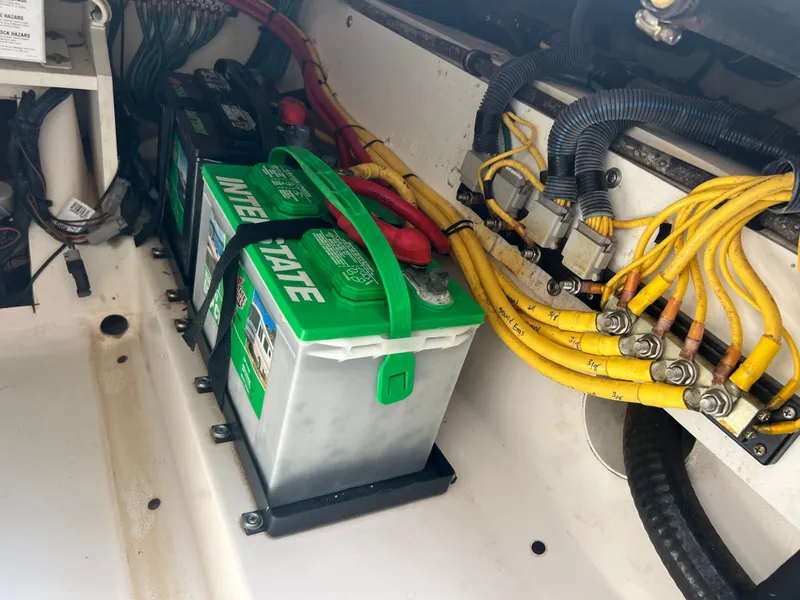 Slide: The Image of Battery compartment of a 2016 Pursuit S 280 Sport boat with wiring and connections. - 35