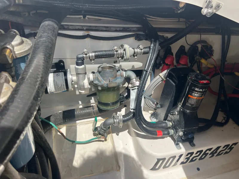 Slide: The Image of Engine compartment of a 2016 Pursuit S 280 Sport boat, showing mechanical components and wiring. - 36