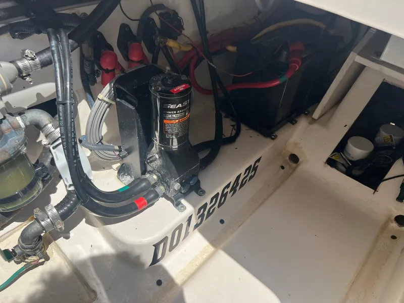 Slide: The Image of Engine compartment of a 2016 Pursuit S 280 Sport boat, showing wiring and components. - 37