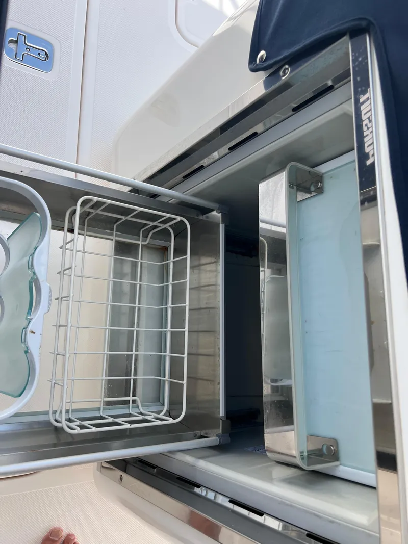 Slide: The Image of Open storage compartment on a 2016 Pursuit S 280 Sport boat. - 38