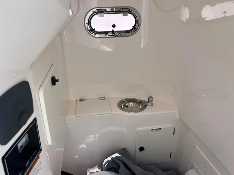 Slide: The Image of 2016 Pursuit S 280 Sport boat interior with sink and porthole window. - 40