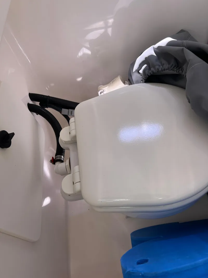 Slide: The Image of 2016 Pursuit S 280 Sport boat interior with compact marine toilet. - 41