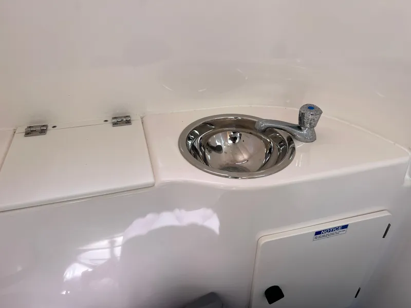 Slide: The Image of 2016 Pursuit S 280 Sport boat sink and storage compartment. - 42