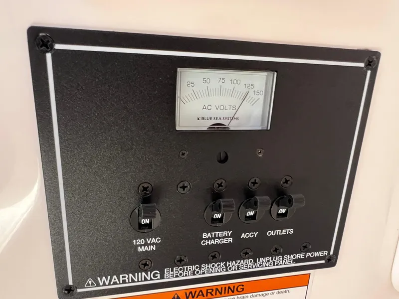 Slide: The Image of Control panel of a 2016 Pursuit S 280 Sport boat with voltage meter and switches. - 43