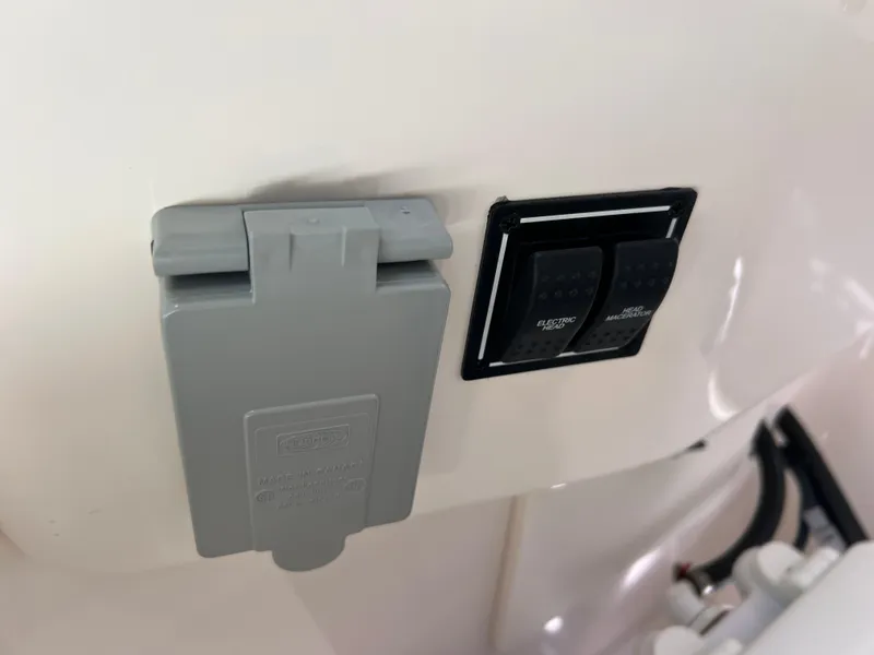 Slide: The Image of 2016 Pursuit S 280 Sport boat electrical outlet and switch panel. - 44