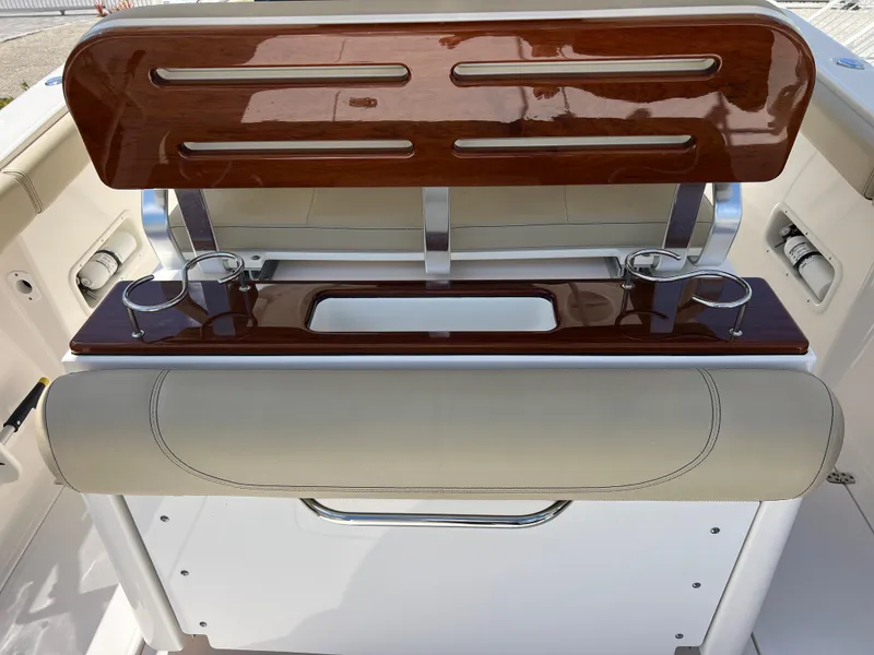 Slide: The Image of 2016 Pursuit S 280 Sport boat interior with polished wood and cup holders. - 46