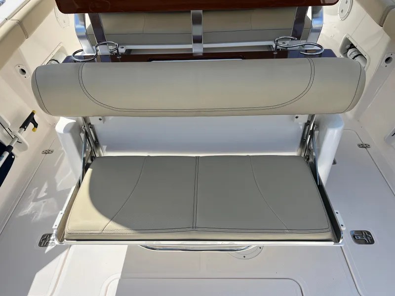Slide: The Image of 2016 Pursuit S 280 Sport boat seat with beige cushions and stainless steel accents. - 47