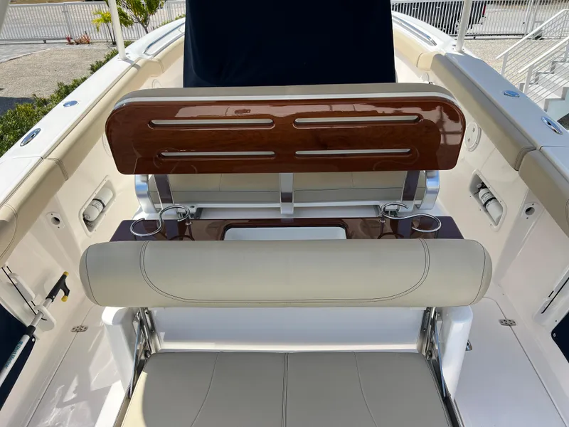 Slide: The Image of 2016 Pursuit S 280 Sport boat seating with wooden accents and cup holders. - 48
