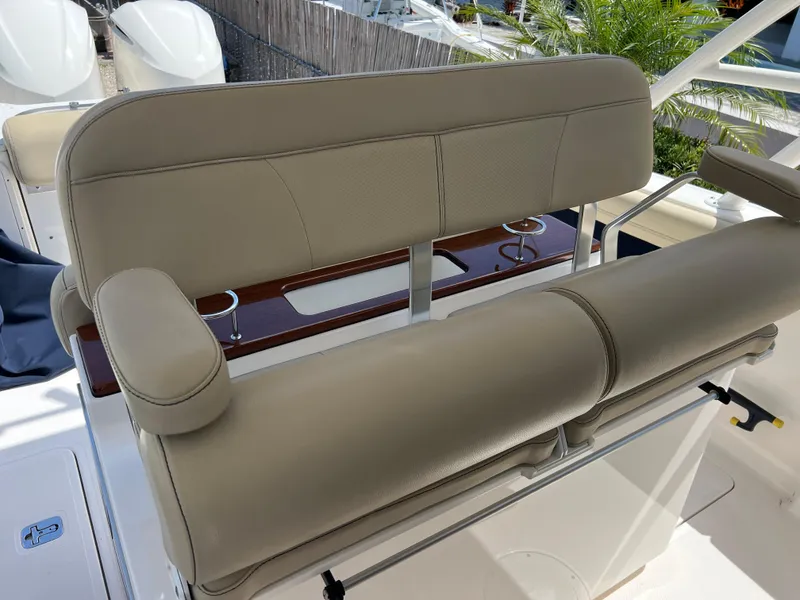 Slide: The Image of 2016 Pursuit S 280 Sport boat seating with beige upholstery and cup holders. - 49