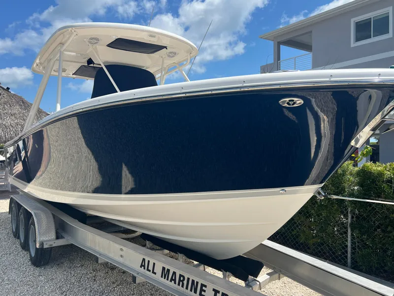 Slide: The Image of 2016 Pursuit S 280 Sport boat on trailer, blue hull, sunny day. - 5