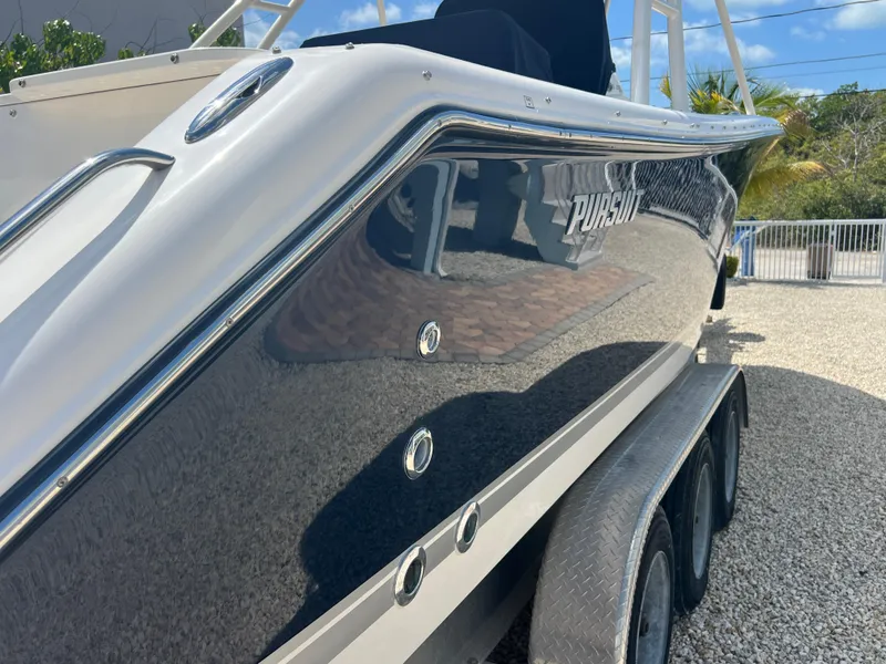 Slide: The Image of 2016 Pursuit S 280 Sport boat on trailer, glossy finish, outdoor setting. - 7