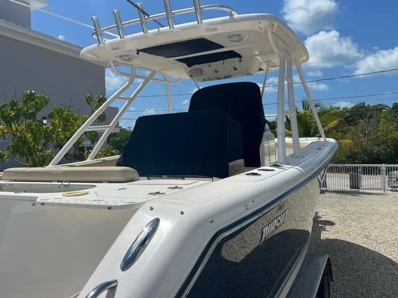 Slide: The Image of 2016 Pursuit S 280 Sport boat with sleek design, docked outdoors under a clear blue sky. - 8