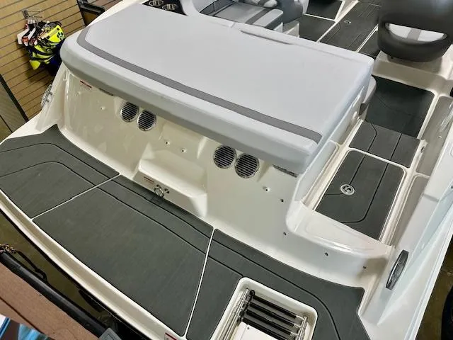 Slide: The Image of 2025 Bayliner V20i boat interior with gray seating and deck, showcasing modern design. - 2