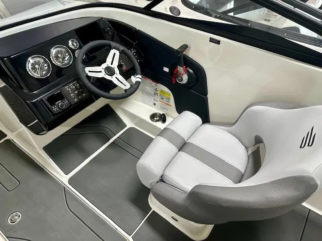 Slide: The Image of 2025 Bayliner V20i boat cockpit with modern steering wheel and comfortable seating. - 6