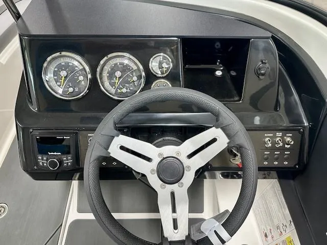 Slide: The Image of 2025 Bayliner V20i dashboard with steering wheel, gauges, and control panel. - 7