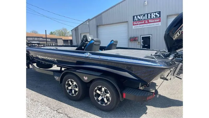 Slide: The Image of 2025 Phoenix 721 ZXL boat parked outside Anglers dealership, showcasing sleek design and dual seats. - 6