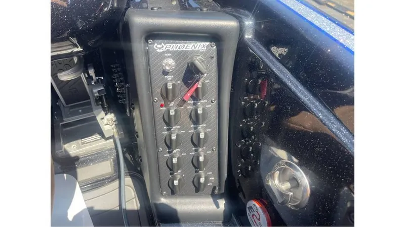 Slide: The Image of Control panel of 2025 Phoenix 721 ZXL boat with switches and dials. - 9