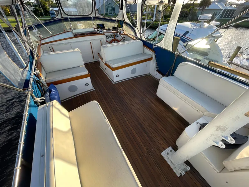 Slide: The Image of 1985 Grand Banks 42 Motoryacht interior with spacious seating and wooden flooring. - 11