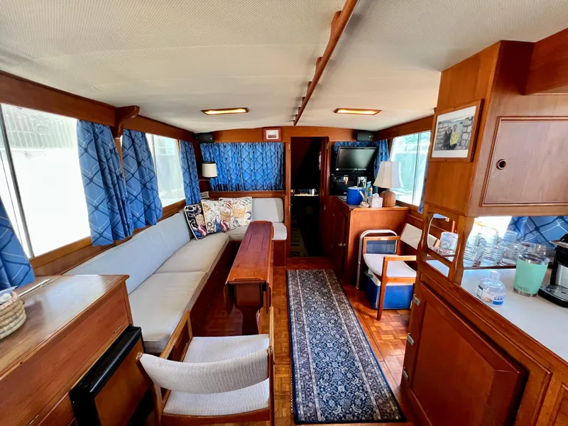 Slide: The Image of Interior of 1985 Grand Banks 42 Motoryacht with cozy seating and elegant wood finishes. - 18