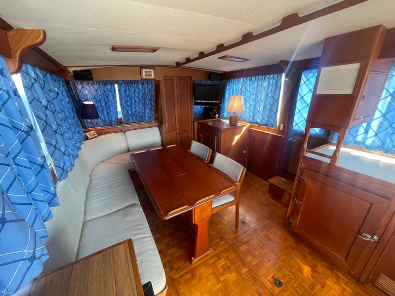 Slide: The Image of Interior of 1985 Grand Banks 42 Motoryacht with wood furnishings and blue curtains. - 20