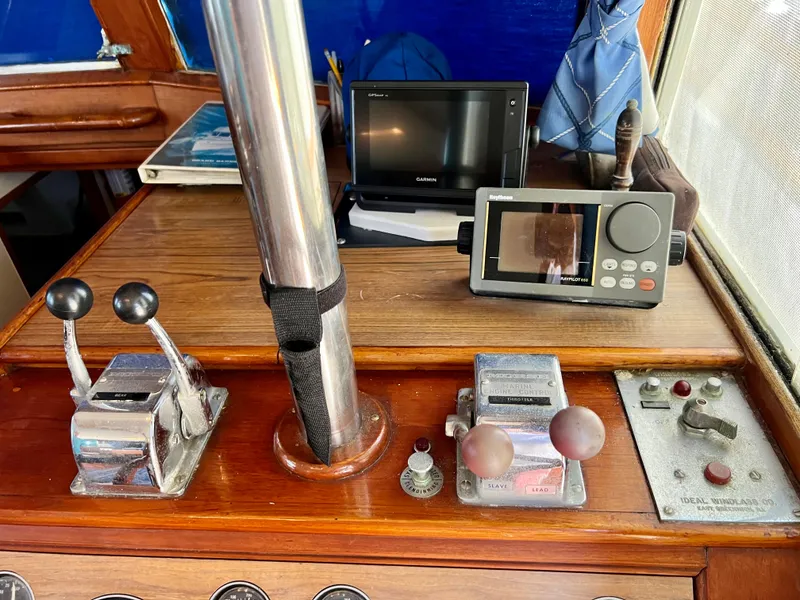 Slide: The Image of Control panel of a 1985 Grand Banks 42 Motoryacht with navigation equipment and throttle levers. - 26