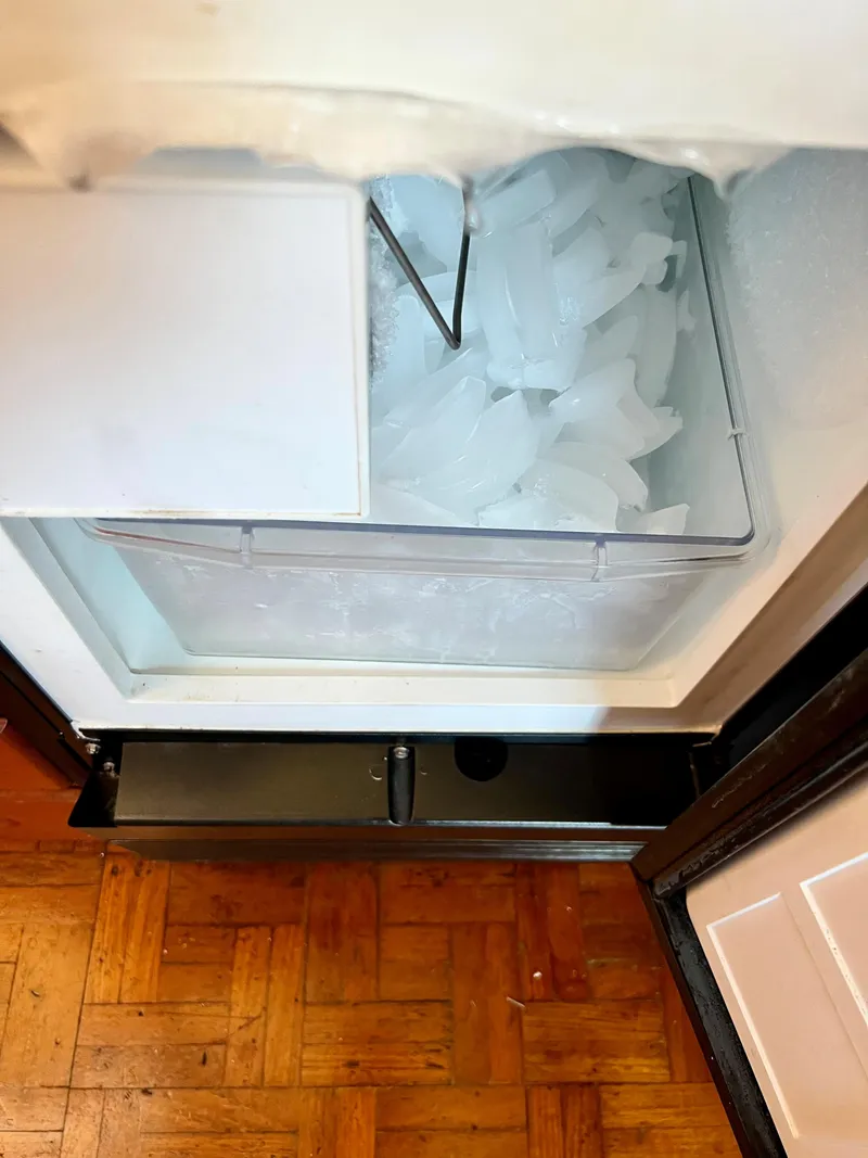 Slide: The Image of Ice maker inside a 1985 Grand Banks 42 Motoryacht, with ice cubes visible. - 28