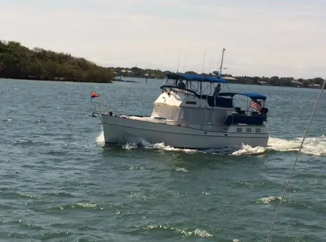 Slide: The Image of 1985 Grand Banks 42 Motoryacht cruising on a sunny day in open waters. - 3