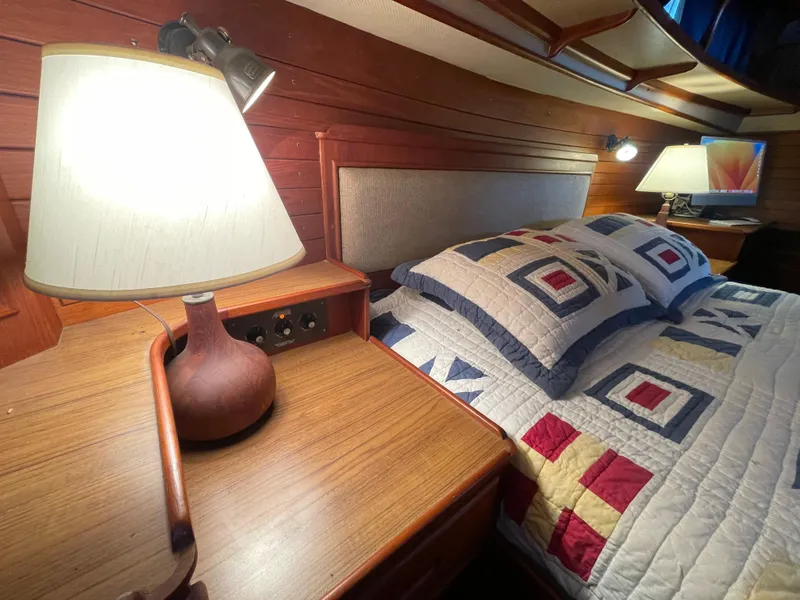Slide: The Image of Cozy bedroom in 1985 Grand Banks 42 Motoryacht with quilted bedding and wooden interior. - 30