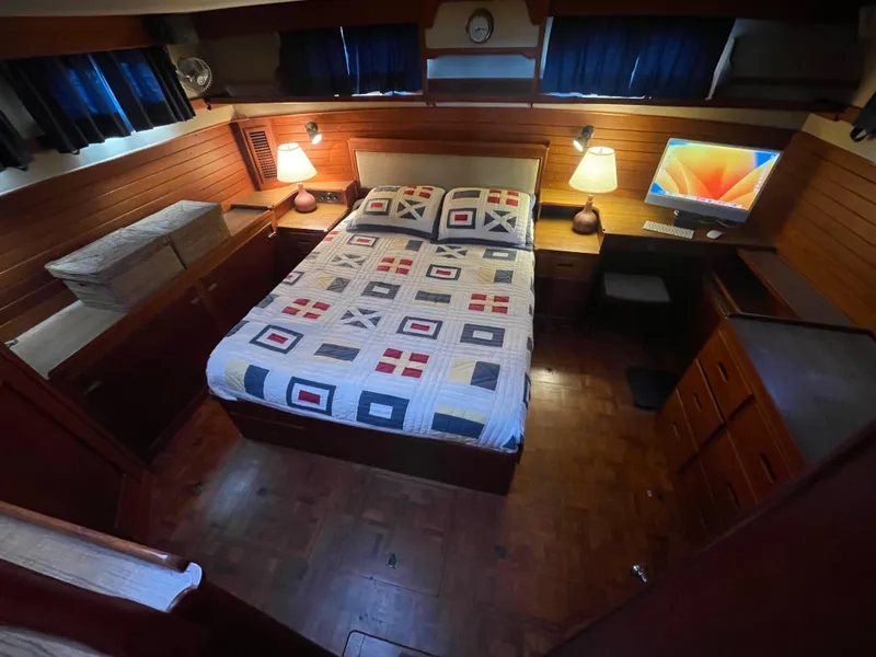 Slide: The Image of Cozy bedroom in 1985 Grand Banks 42 Motoryacht with quilted bedspread and wooden interior. - 32
