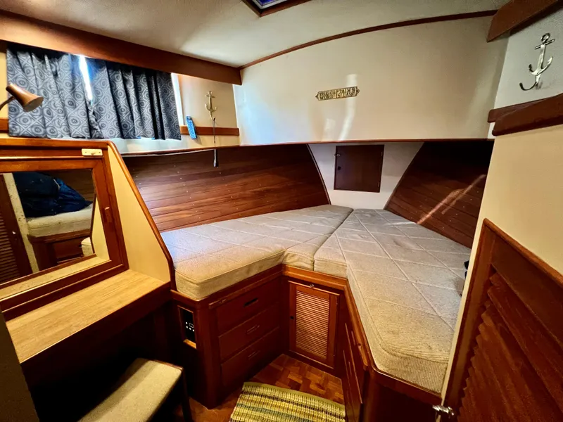 Slide: The Image of Cozy cabin interior of 1985 Grand Banks 42 Motoryacht with wood paneling and twin beds. - 35