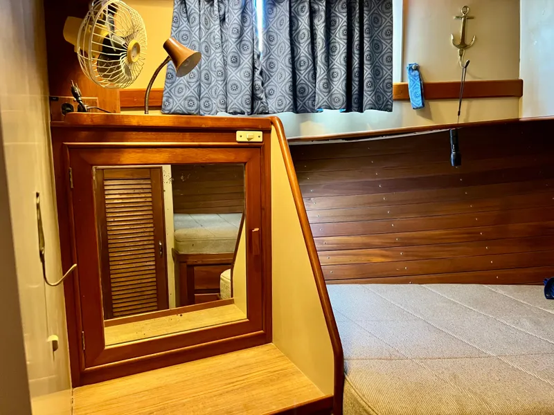 Slide: The Image of Cozy cabin interior of 1985 Grand Banks 42 Motoryacht with wood paneling and mirror. - 36