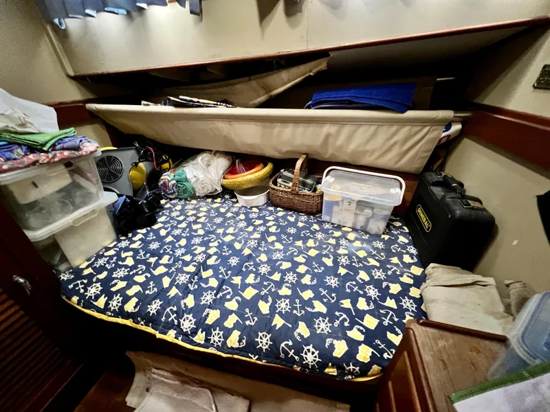 Slide: The Image of Cozy cabin interior of 1985 Grand Banks 42 Motoryacht with nautical-themed bedding and storage. - 37