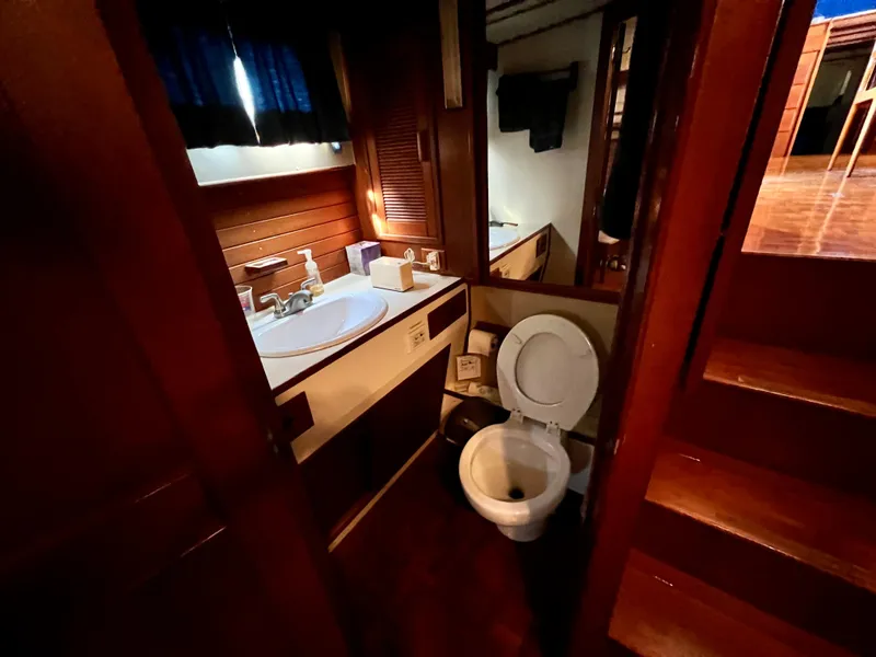 Slide: The Image of 1985 Grand Banks 42 Motoryacht bathroom with sink, toilet, and wooden interior. - 38