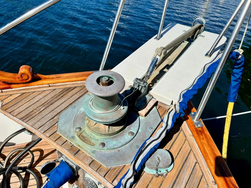 Slide: The Image of 1985 Grand Banks 42 Motoryacht deck with anchor winch and wooden details. - 40