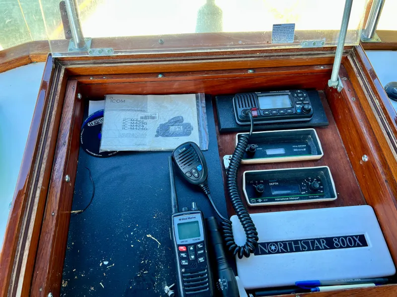 Slide: The Image of Control panel of a 1985 Grand Banks 42 Motoryacht with communication devices and navigation equipment. - 41