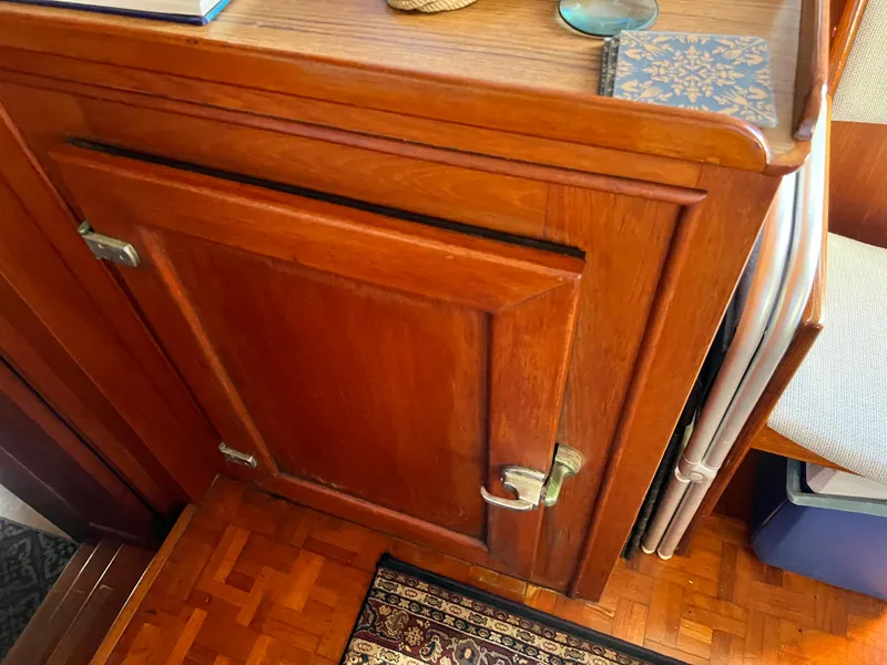 Slide: The Image of Wooden cabinet interior of 1985 Grand Banks 42 Motoryacht, featuring classic design and parquet flooring. - 42