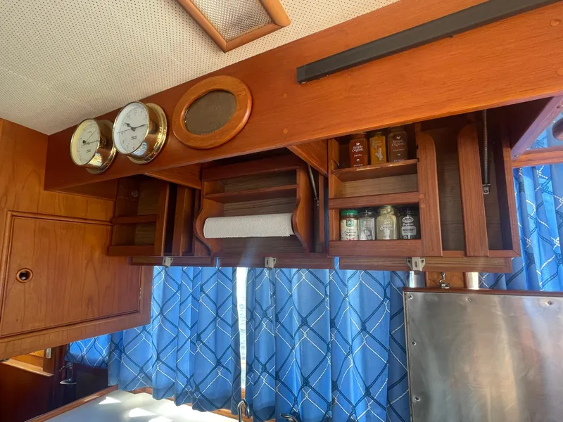 Slide: The Image of Interior of 1985 Grand Banks 42 Motoryacht with wooden cabinets and nautical decor. - 49