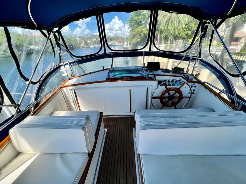Slide: The Image of 1985 Grand Banks 42 Motoryacht helm with blue canopy and wooden steering wheel. - 7
