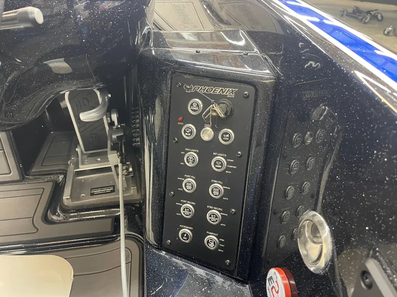 Slide: The Image of Control panel of a 2025 Phoenix 21 XE boat, featuring switches and ignition. - 11