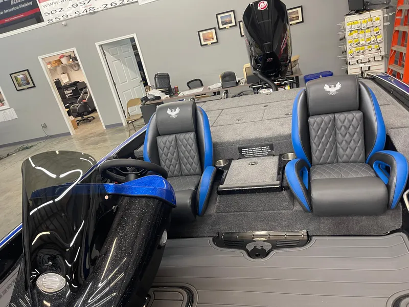 Slide: The Image of Interior of 2025 Phoenix 21 XE boat with blue and black seating. - 7