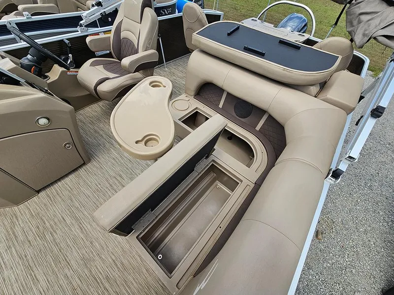 Slide: The Image of 2020 Bennington 22 SSXP pontoon boat interior with beige seating and storage compartments. - 13