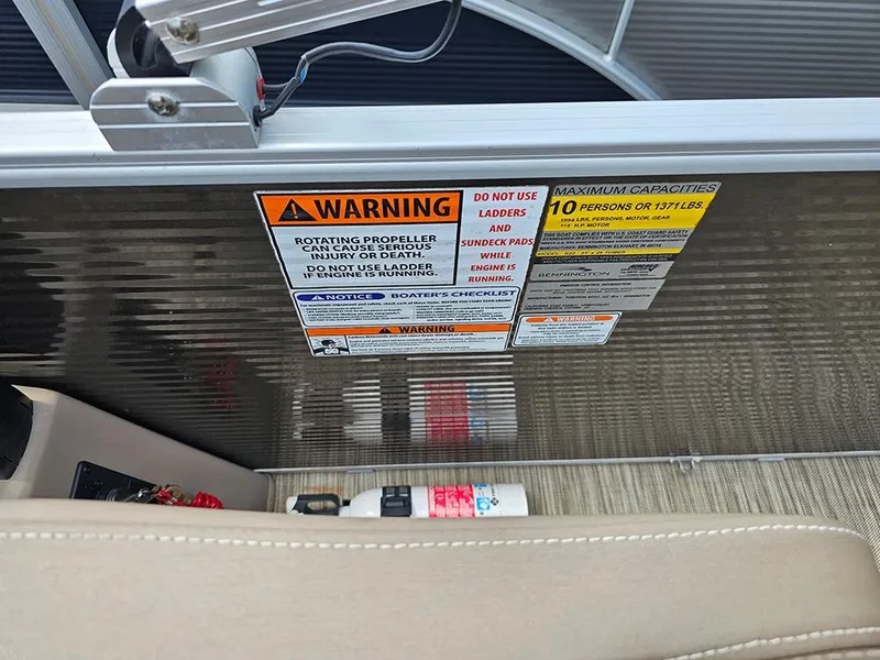 Slide: The Image of 2020 Bennington 22 SSXP boat warning labels and safety instructions near seating area. - 15