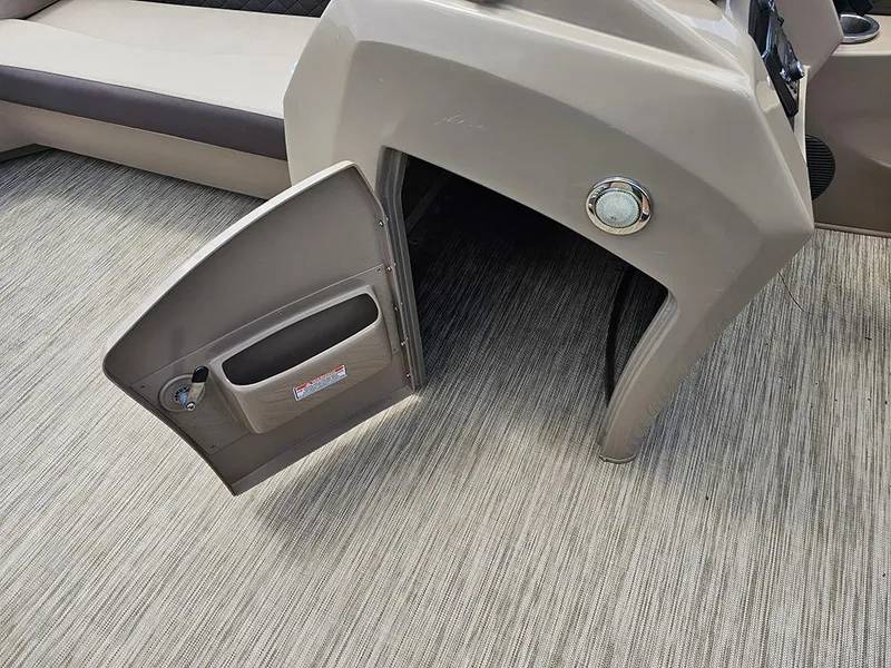 Slide: The Image of 2020 Bennington 22 SSXP boat console with open storage compartment on textured flooring. - 16