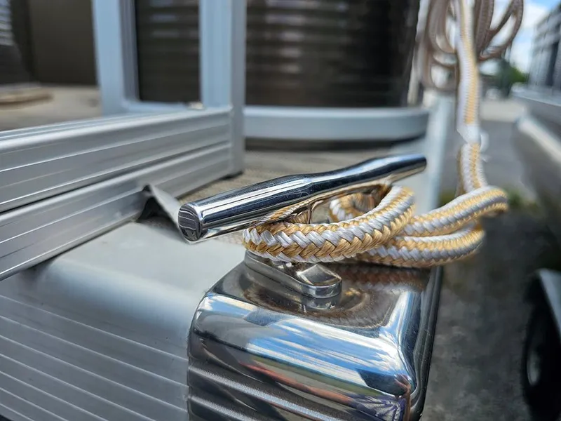 Slide: The Image of Close-up of a 2020 Bennington 22 SSXP boat cleat with rope tied securely. - 20