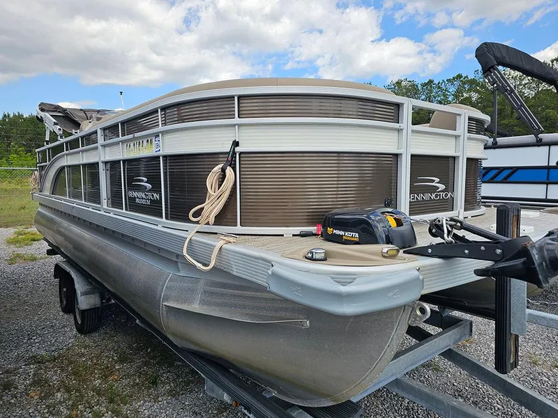Slide: The Image of 2020 Bennington 22 SSXP pontoon boat on trailer, parked outdoors under cloudy sky. - 3