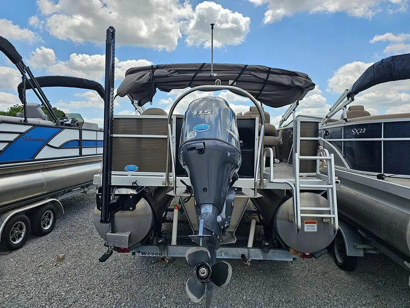 Slide: The Image of 2020 Bennington 22 SSXP pontoon boat with outboard motor, parked on gravel lot. - 5